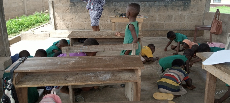 students writing on the floor