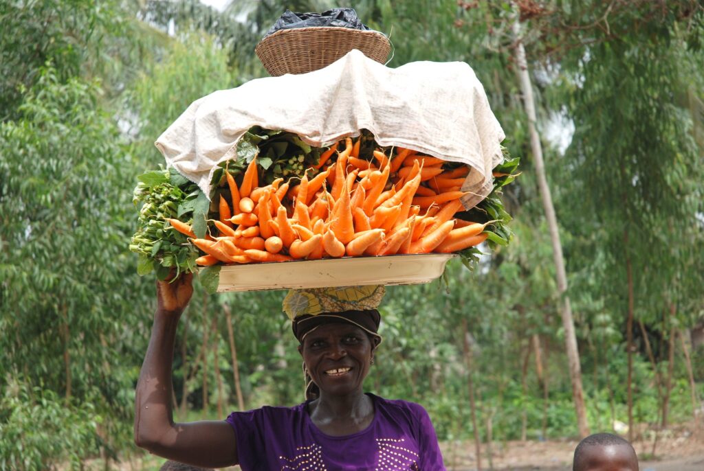 A woman in Benin carrying produce on her head