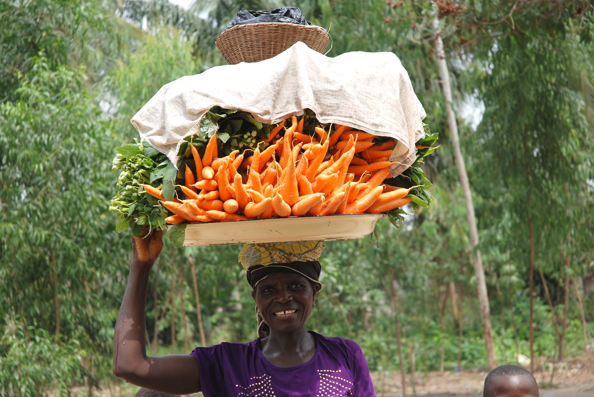 A woman in Benin carrying produce on her head