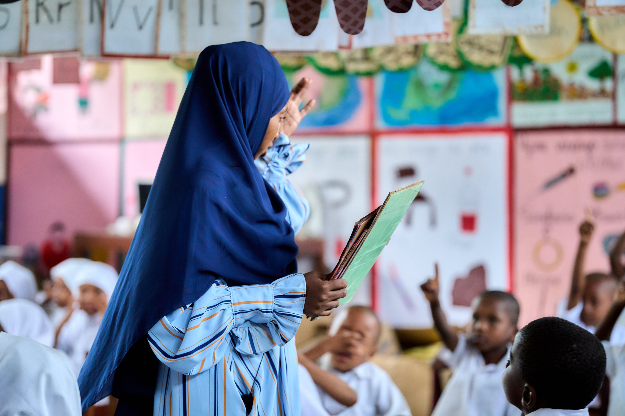 A teacher and her students in Tanzania.